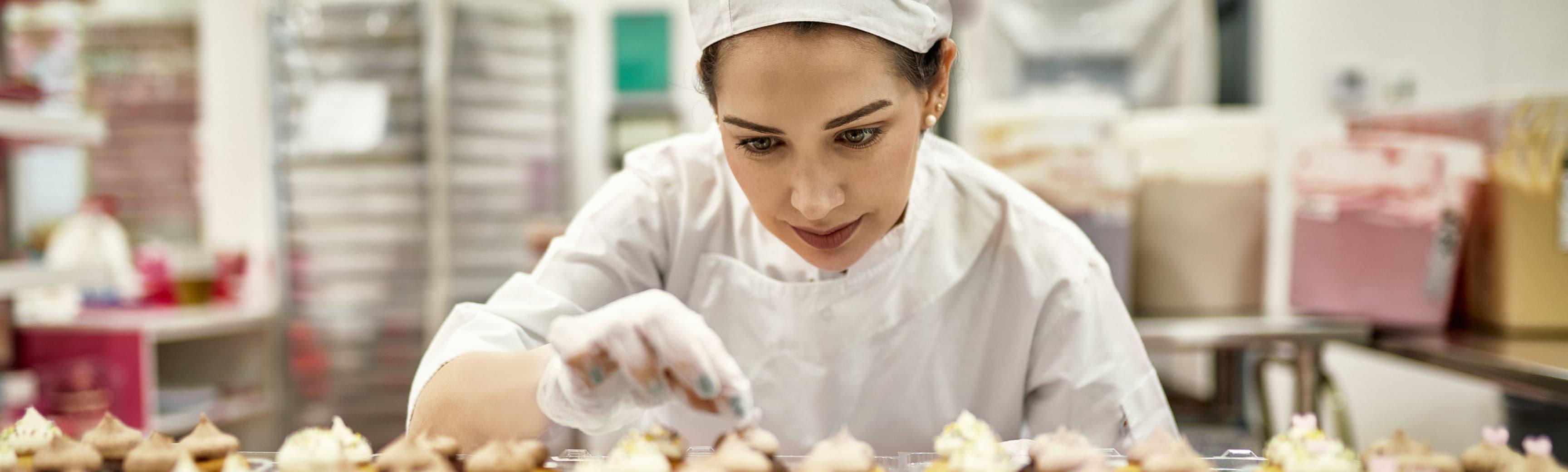 a baker finishes off some pastries